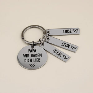 Personalisierter Papa wir haben dich lieb Schlüsselanhänger mit drei Namensanhängern für Luise, Leon und Oskar.
