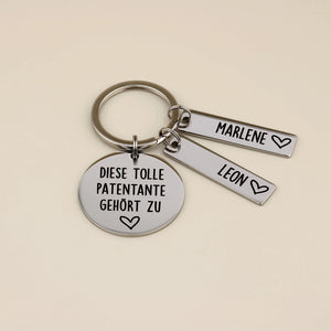 Schlüsselanhänger „Diese tolle Patentante gehört zu“ mit den Namensanhängern Marlene und Leon.