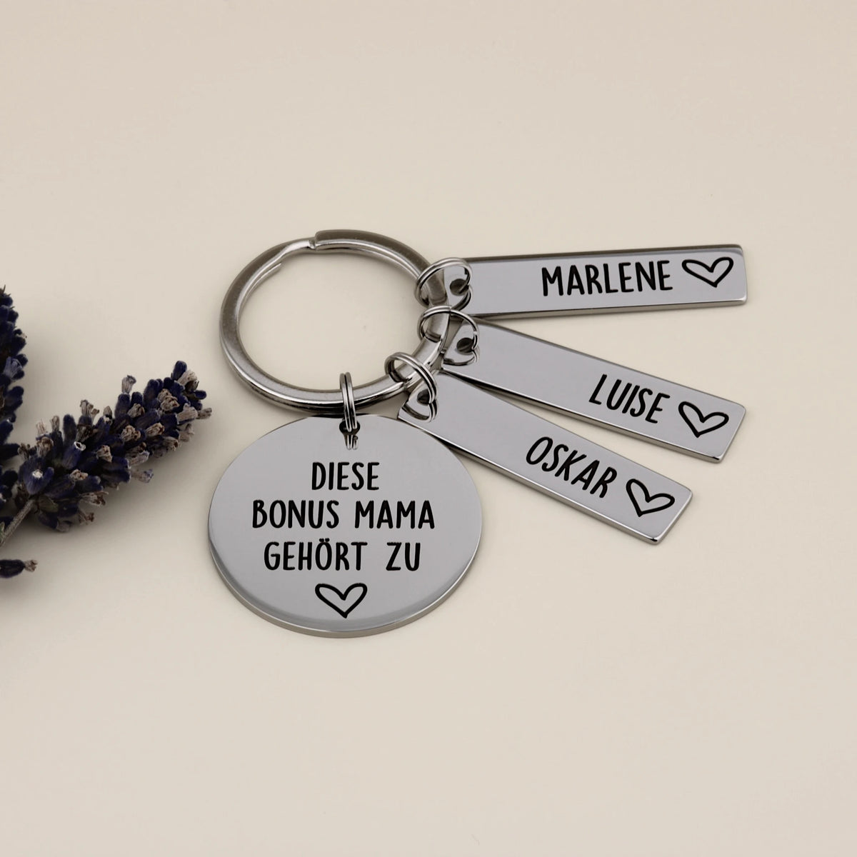 Personalisierter Bonus-Mama-Schlüsselanhänger mit drei Namensanhängern und Lavendel.