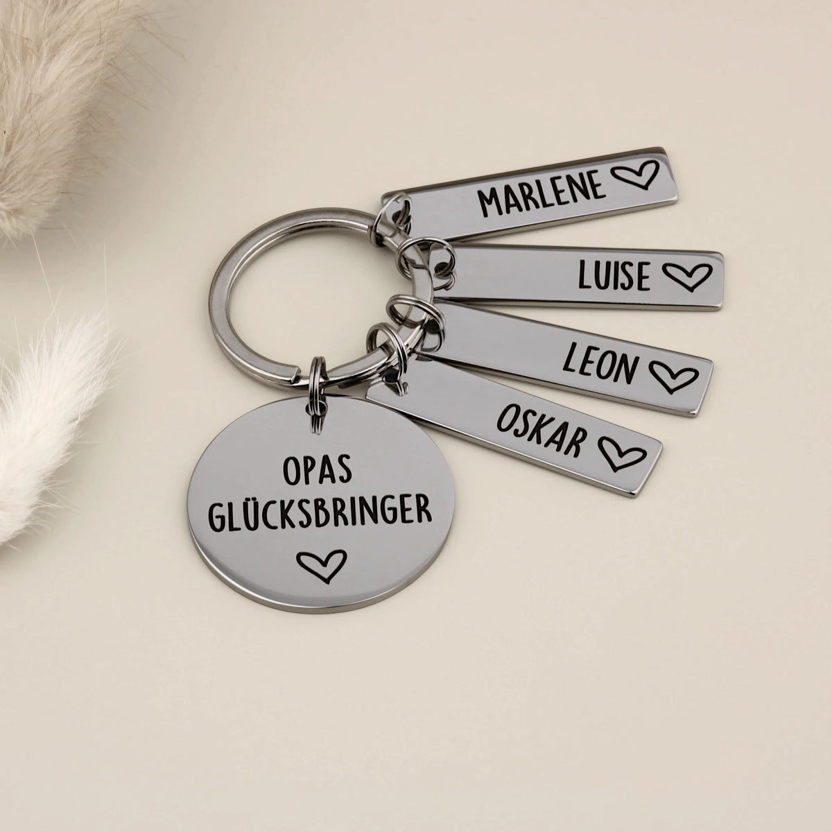 Dekorative Ansicht des Schlüsselanhängers „Opas Glücksbringer“ mit vier Namensanhängern.
